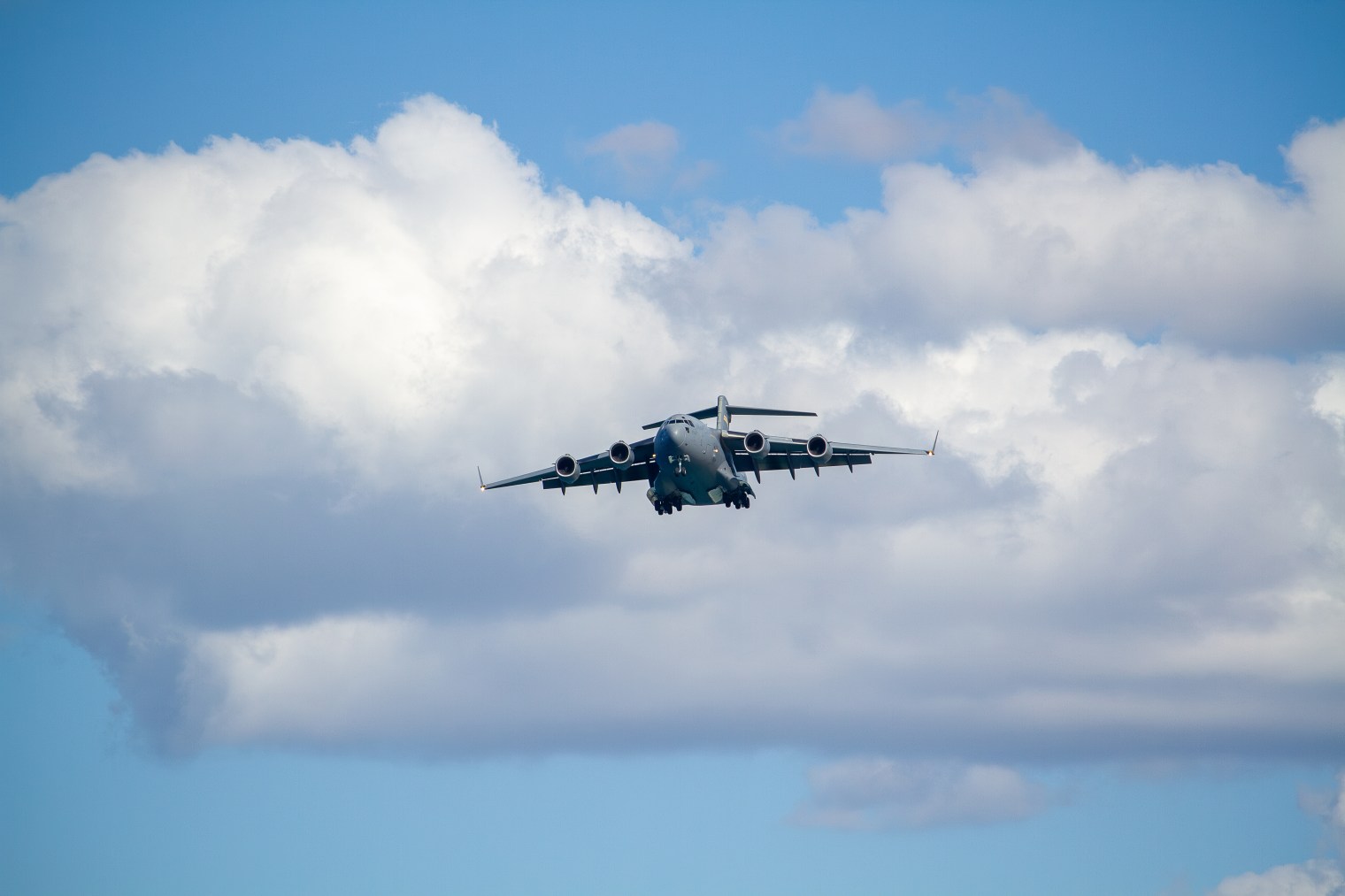 adobestock_2172009128 military aircraft on approach with landing gear down, representing flight management systems for defense