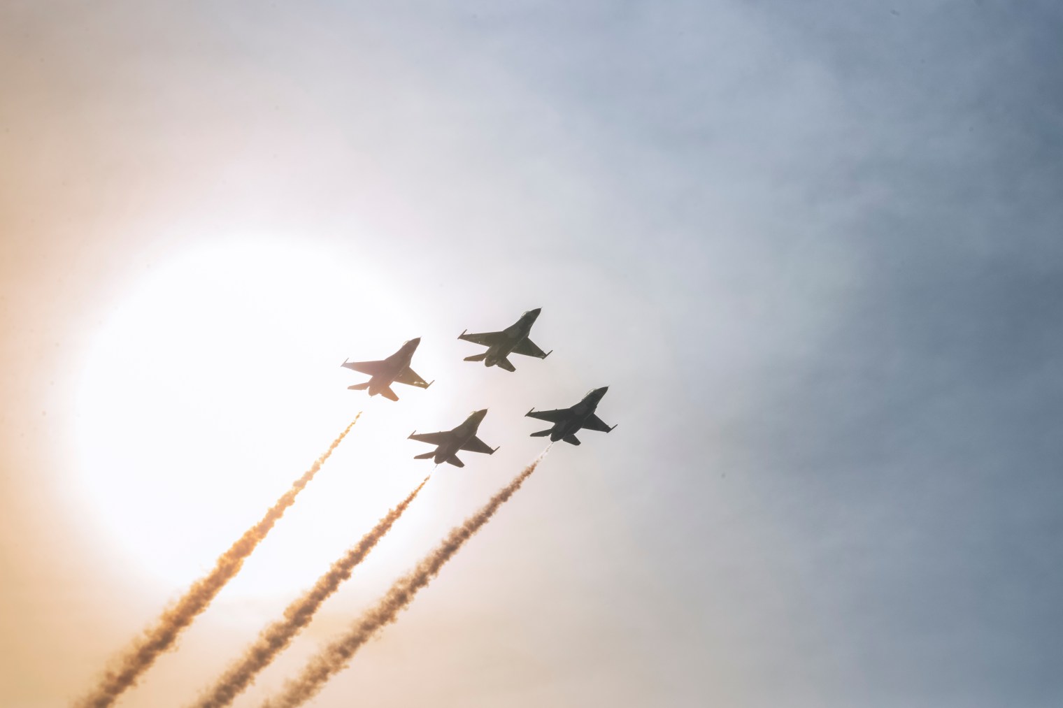 adobestock_424298605 Fighter jets flying in tight formation against a hazy sky, illustrating fly-by-wire flight control software for defense