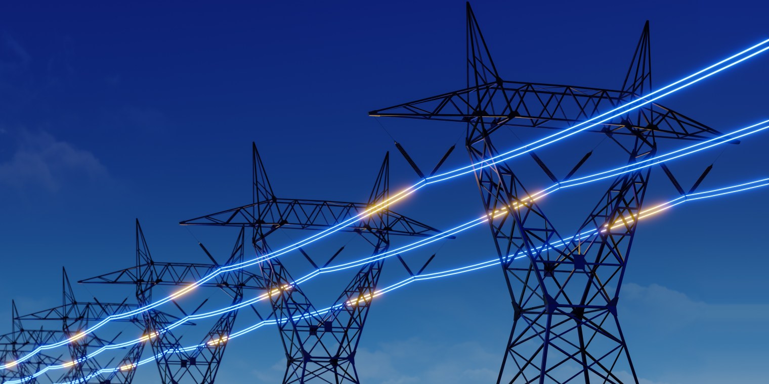 adobestock_715890097 High-voltage transmission towers with glowing power lines against a blue sky, representing safety-critical energy systems